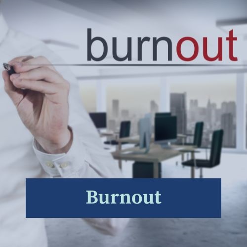 The word Burnout underlined by a hand of a man, and in the background office chairs and desks, depicting a corporate workplace.