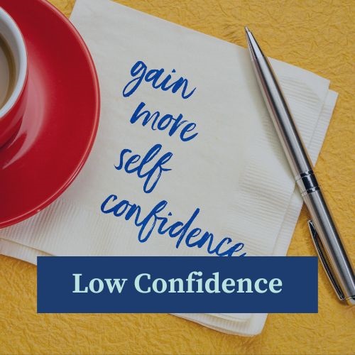 A piece of paper under a cup and saucer on one side, and a pen on the other, with handwriting on it that says gain more self confidence